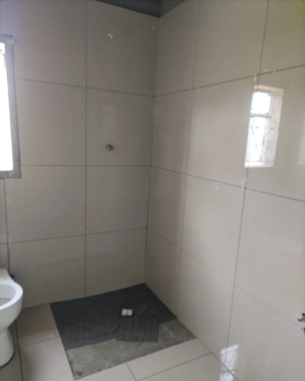 Renovated bathroom with polished wall and floor tiles