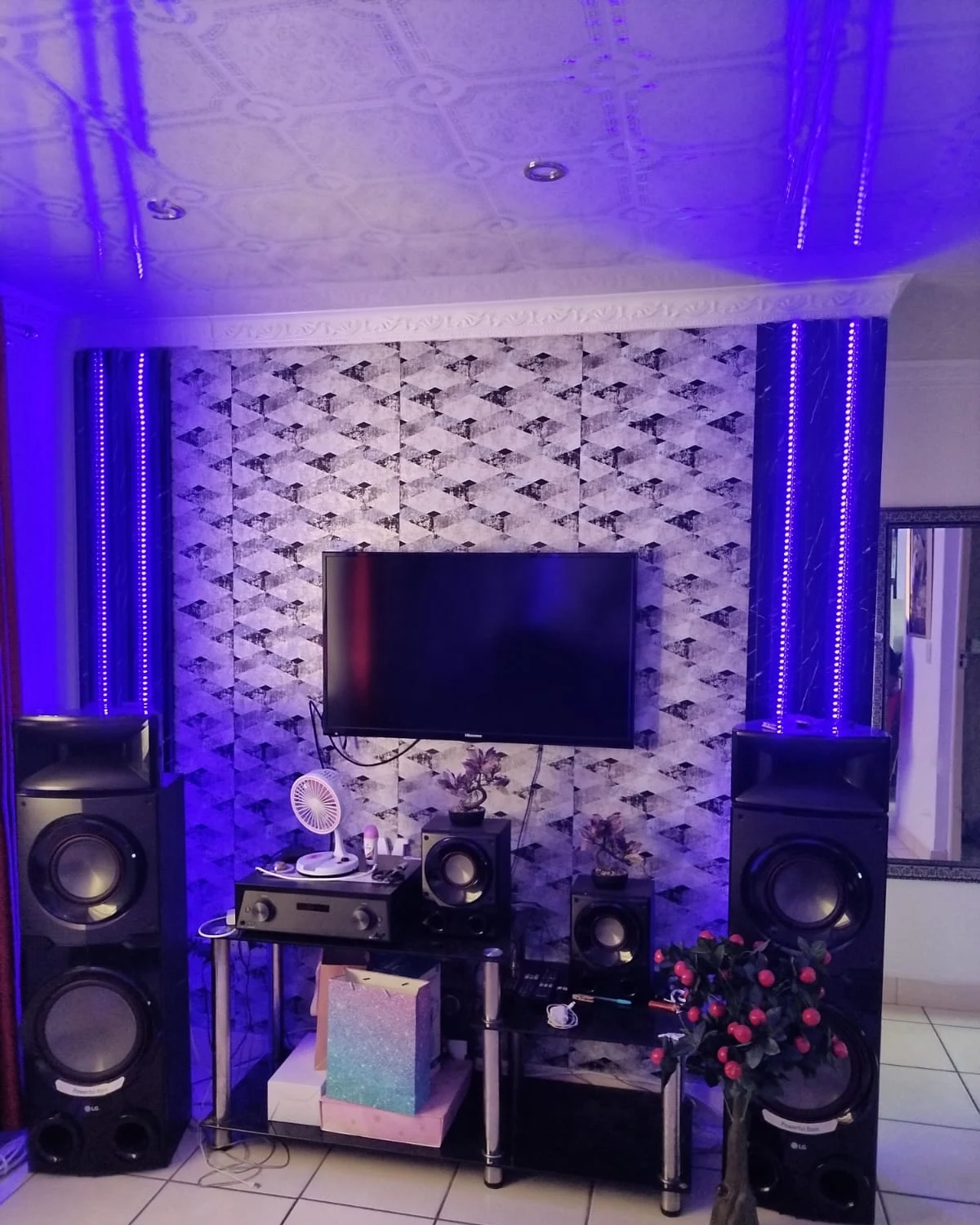Entertainment lounge feature wall with illuminated blue LED columns